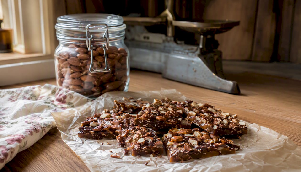 Handcrafted English toffee with storage containers on marble