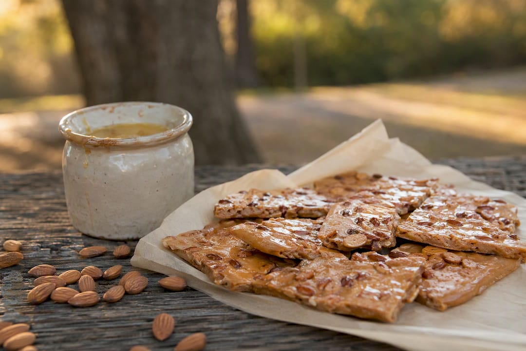 Small batch English almond toffee cooling on parchment