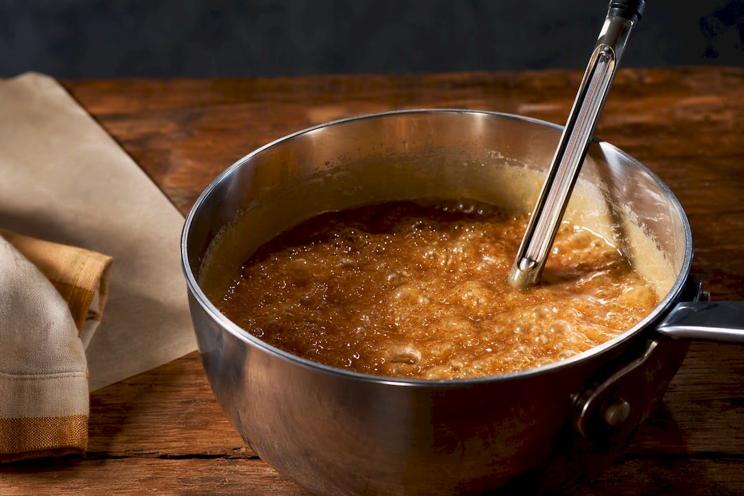 Toffee syrup cooking with candy thermometer